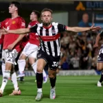 Grimsby stun Manchester United in Carabao Cup thriller as fans storm the pitch