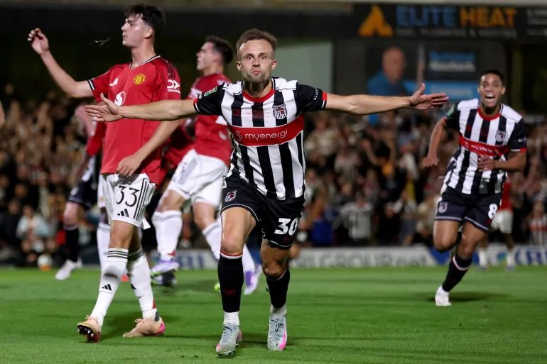 Grimsby stun Manchester United in Carabao Cup thriller as fans storm the pitch